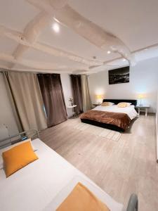 a large bedroom with a bed and two tables at Douro sunset lounge in Porto