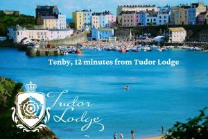 a view of a town with a body of water at Tudor Lodge Bed & Breakfast in Manorbier