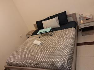 a bed with a tray on it in a room at Top House Zayed Airport - With Free Taxi in Abu Dhabi