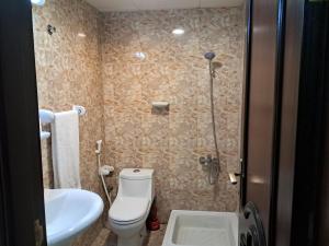 a bathroom with a toilet and a sink and a shower at Top House Zayed Airport in Abu Dhabi