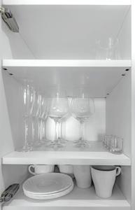a shelf with wine glasses and plates in a refrigerator at Tenerifeopenhome Ocean View Costa Adeje in Adeje