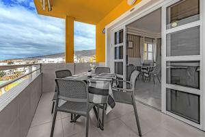 a patio with a table and chairs on a balcony at Tenerifeopenhome Ocean View Costa Adeje in Adeje