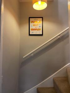 a stairway with a sign on the wall at Cosy 1BD Heritage Cottage in Saltaire, Shipley in Shipley