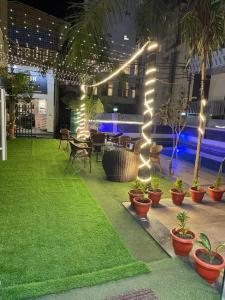 a patio with potted plants and lights at The Wraveler Tapovan , Rooms & Dorms in Rishīkesh
