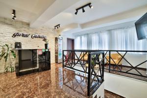 a living room with a staircase and a brick wall at Garni House 46 Plus in Belgrade