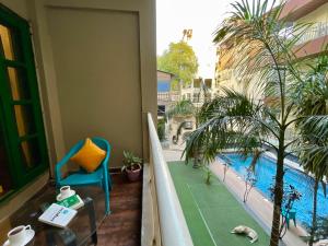 a balcony with a view of a swimming pool at The Wraveler Tapovan , Rooms & Dorms in Rishīkesh