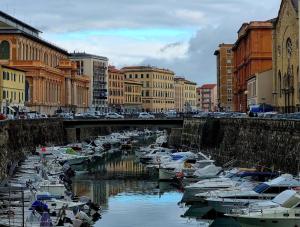 a group of boats docked in a canal in a city at CASA FELICITA' in Livorno
