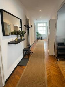 a hallway with a large mirror on the wall at House Elza in Ljubljana