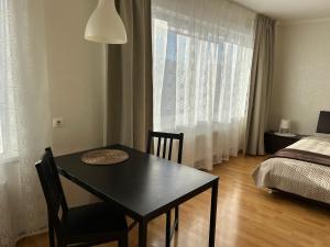 a room with a table and a bed and a bedroom at Maxima apartments in Daugavpils