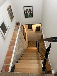 a staircase in a house with a dog on the wall at Moonlight cottage france in Courchamps