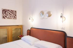 a bed with two white pillows in a room at Hotel Castello in Turin