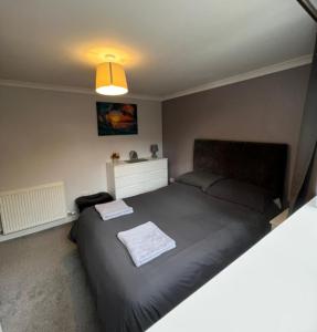 a bedroom with a large bed in a room at 5 Riverside Place Thurso. 2 bed, 2 bathrooms. in Thurso
