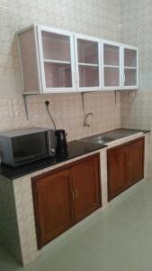 a kitchen with a sink and a microwave at Bamboo House BnB in Bondeni