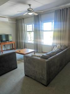 a living room with a couch and a coffee table at Entire specious 3 bedrooms house in Durban in Durban