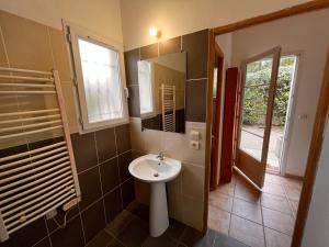 a bathroom with a sink and a mirror at LES VIEUX CABASSOLS VENELLES in Venelles