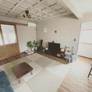 a living room with a tv and a table at Bridge33 CAFE AND HOSTEL in Takagi