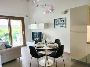 cocina y comedor con mesa y sillas en A casa di Nala, en Tortoreto Lido