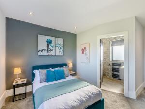 a bedroom with a blue bed and a window at Dewhurst Farm in Langho