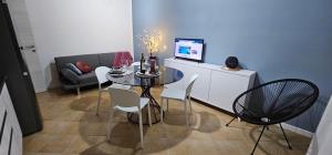 a dining room with a table and a couch at Chia Sweet Home in Chia