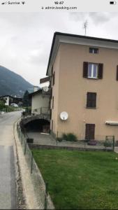 a building on the side of a road next to a street at Appartamento in Attico in Poschiavo