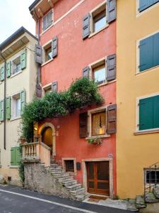 an apartment building with stairs and plants on it at Welcome Traveller BERNARDO HOUSE in Garda