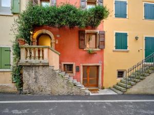 a building with a staircase on the side of it at Welcome Traveller BERNARDO HOUSE in Garda
