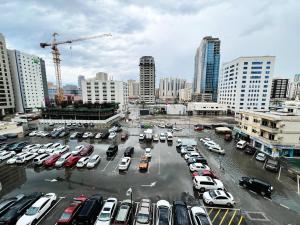 a parking lot full of cars in a city at Sam Home in Sharjah
