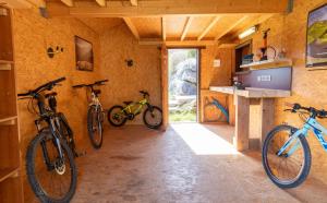 three bikes are parked in a room with a wall at Gîte Le Bédat in Ayzac-Ost