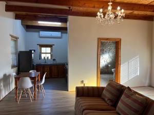 a living room with a couch and a table at Stoneridge in Oudtshoorn