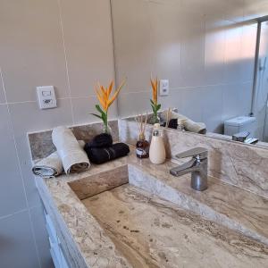 a bathroom counter with a sink and a mirror at Posada Nihal in Búzios