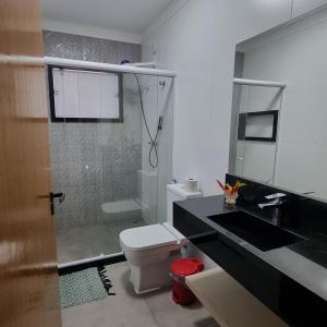 a bathroom with a shower and a toilet and a sink at Posada Nihal in Búzios