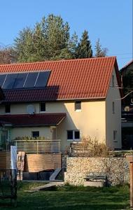 a house with a red roof with solar panels on it at Haus am Berzdorfer See in Görlitz