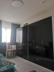 a bedroom with a large black cabinet and a table at Bob's Zimmer in Bielefeld