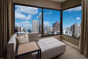 a living room with a couch and a large window at Hyatt Regency Austin in Austin