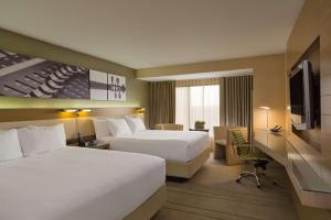 a hotel room with two beds and a television at Hyatt Regency Austin in Austin