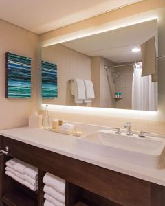 a bathroom with a sink and a large mirror at Hyatt Regency Austin in Austin