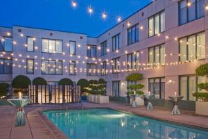 a hotel with a swimming pool in front of a building at Hyatt Centric Fisherman's Wharf San Francisco in San Francisco