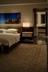 a hotel room with a bed and a carpet at Park Hyatt Hotel and Residences, Hyderabad in Hyderabad