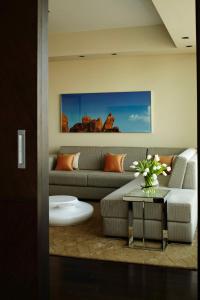 a living room with a couch and a table at Park Hyatt Hotel and Residences, Hyderabad in Hyderabad