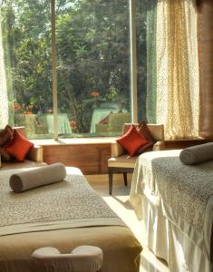 a bedroom with two beds and a large window at Park Hyatt Hotel and Residences, Hyderabad in Hyderabad