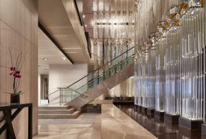 a lobby with a staircase and a glass wall at Grand Hyatt Melbourne in Melbourne