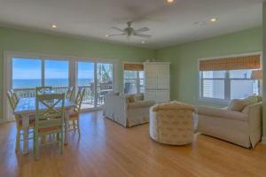 a living room with a table and a dining room at Beachcomber in Cape San Blas