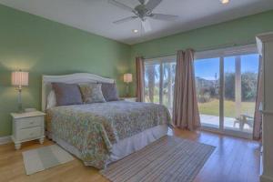 a bedroom with a bed and a large window at Beachcomber in Cape San Blas