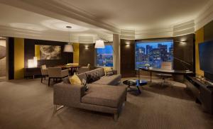 a living room with a couch and a dining room at Grand Hyatt Melbourne in Melbourne