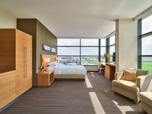 a hotel room with a bed and a large window at Hyatt Place Amsterdam Airport in Hoofddorp