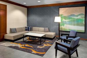 un soggiorno con divano, tavolo e sedie di Hyatt House Boston/Burlington a Burlington