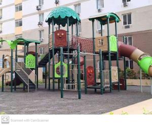 a playground with a slide in front of a building at Adam&Eva Condo Staycation in Lapu Lapu City