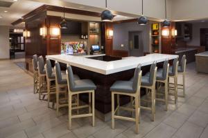 a bar in a restaurant with chairs around it at Hyatt House Boston Waltham in Waltham