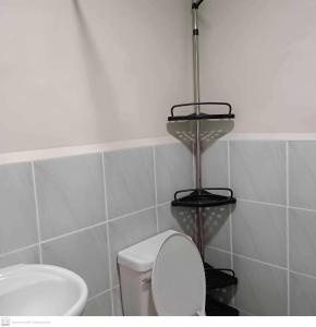 Łazienka z białą toaletą i umywalką w obiekcie Adam&Eva Condo Staycation w mieście Lapu Lapu City