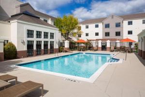a swimming pool in front of a building at Hyatt House Boston Waltham in Waltham